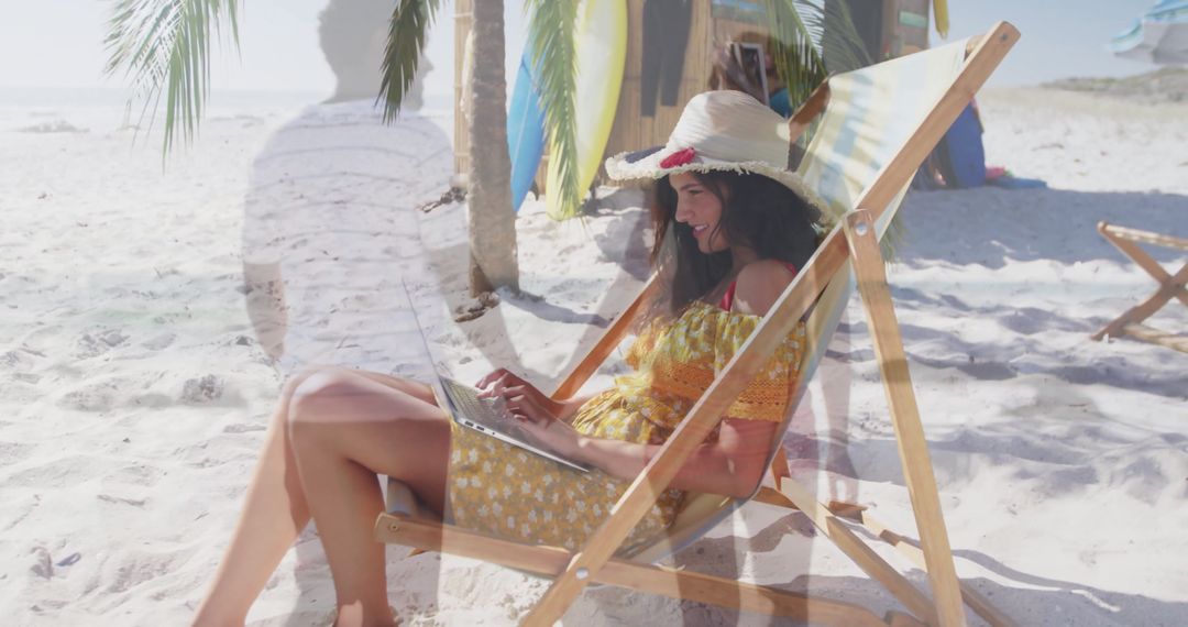 Woman Relaxing on Tropical Beach with Laptop Under Straw Hat