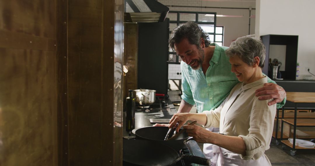 Senior Couple Cooking Together and Smiling in Modern Kitchen - Free Images, Stock Photos and Pictures on Pikwizard.com