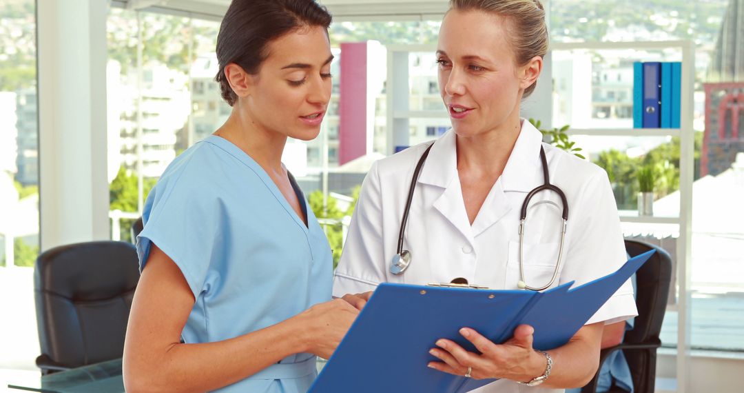 Medical Professionals Discussing Patient Records in Office Setting - Free Images, Stock Photos and Pictures on Pikwizard.com