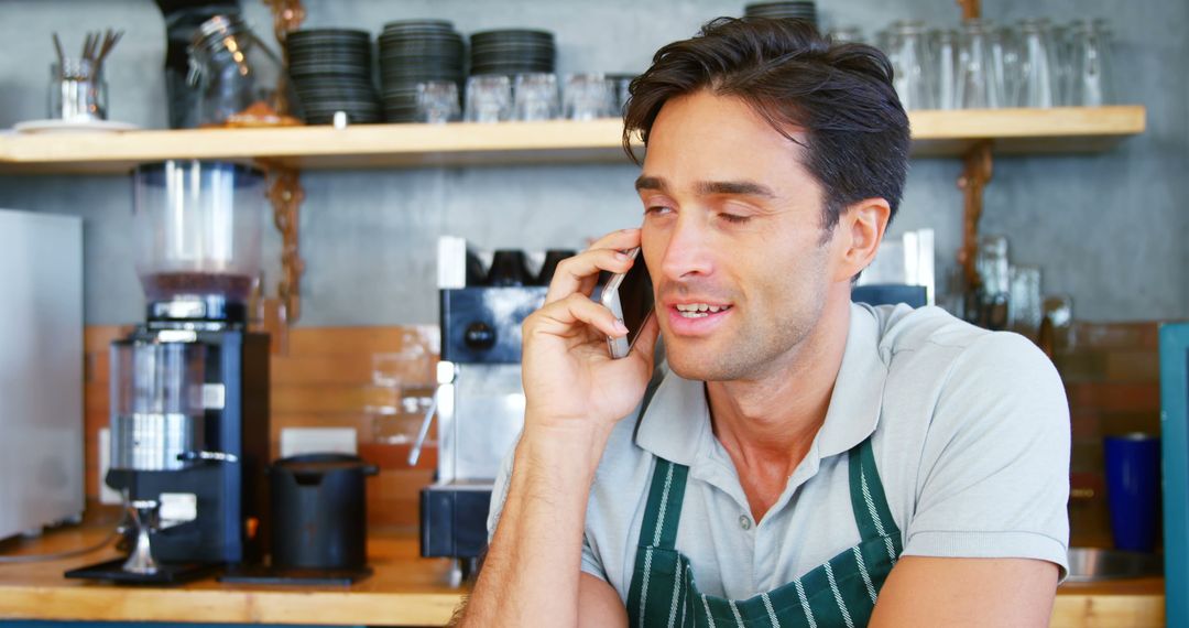 Barista Taking Phone Call at Coffee Shop Counter - Free Images, Stock Photos and Pictures on Pikwizard.com