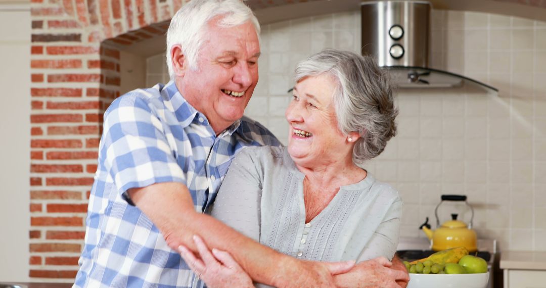 Happy Senior Couple Hugging in Modern Kitchen, Smiling at Each Other - Free Images, Stock Photos and Pictures on Pikwizard.com