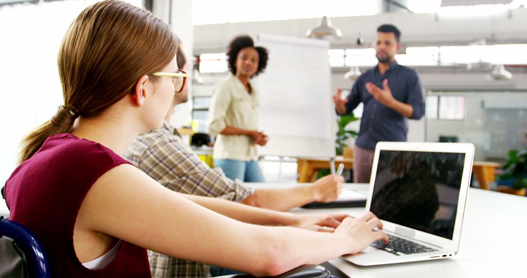 Colleagues Engaged in Office Presentation and Discussion