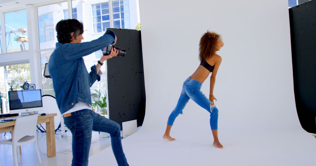 Fashion Photographer Capturing Model Posing in Studio - Free Images, Stock Photos and Pictures on Pikwizard.com