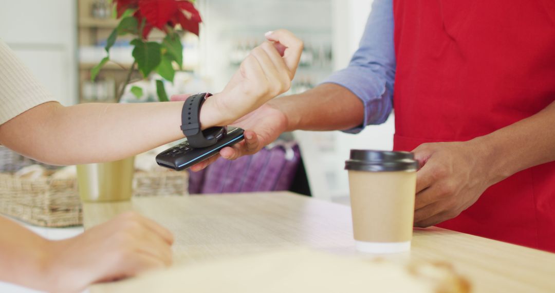 Customer Using Smartwatch for Contactless Payment at Café - Free Images, Stock Photos and Pictures on Pikwizard.com