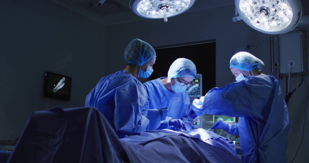 Surgical team performing complex surgery under LED surgical lights in modern operating room