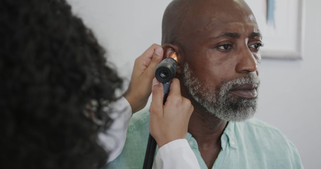 Doctor Examining Mature Man's Ear - Free Images, Stock Photos and Pictures on Pikwizard.com