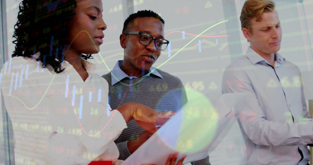 Team Analyzing Financial Data with Graphs Overlay in Modern Office