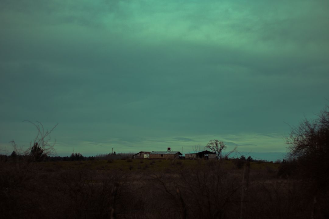 Rural Landscape with Isolated Farmhouse Under Overcast Sky - Free Images, Stock Photos and Pictures on Pikwizard.com