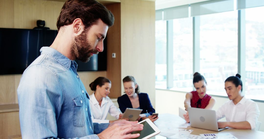 Business Team Collaborating in Modern Office with Digital Devices