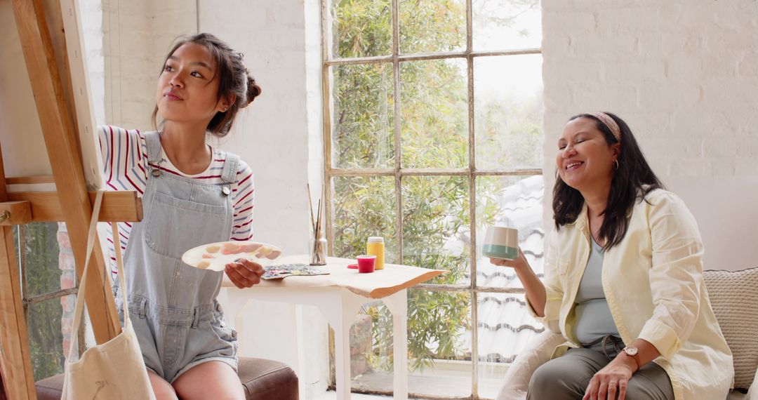 Mother and Daughter Creating Art in Sunlit Studio