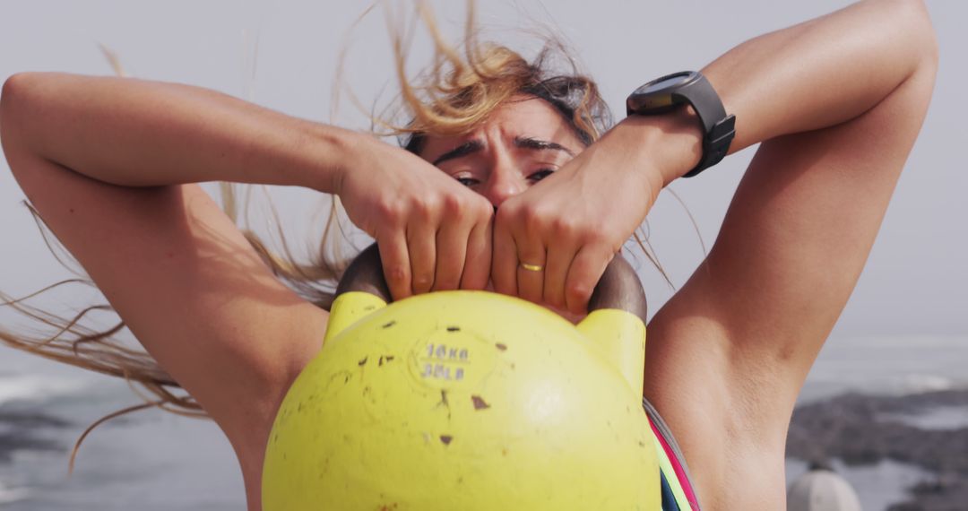 Woman Lifting Yellow Kettlebell Outdoors during Workout - Free Images, Stock Photos and Pictures on Pikwizard.com