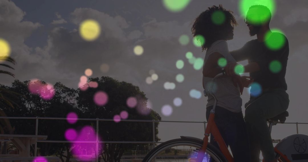 Romantic Couple Embracing with Bicycle on Scenic Waterfront at Sunset