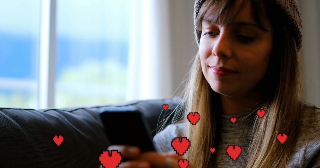 Woman Texting on Couch with Digital Hearts Overlay