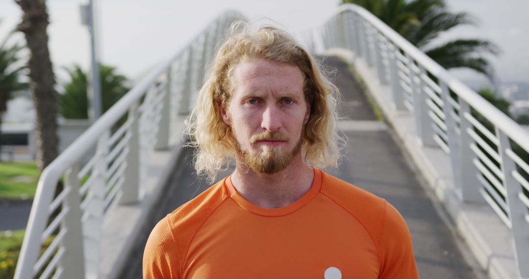 Confident Athlete with Blond Hair Standing on Modern Bridge - Free Images, Stock Photos and Pictures on Pikwizard.com