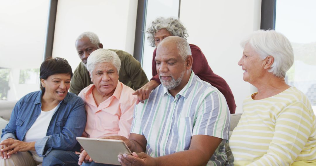 Group of Senior Friends Using Tablet Together Indoors - Free Images, Stock Photos and Pictures on Pikwizard.com