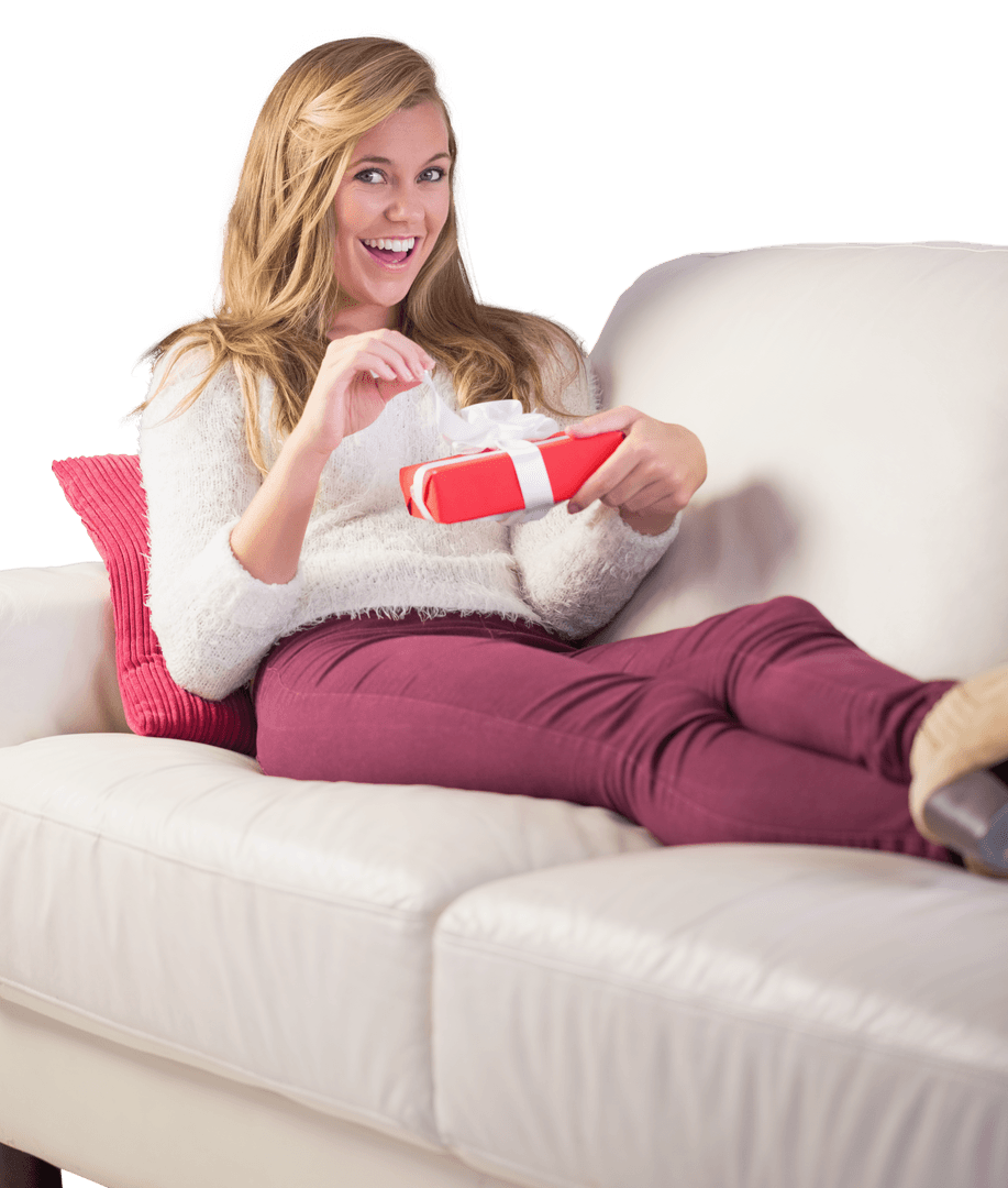 Joyful Woman Opening Gift on Sofa with Transparent Background