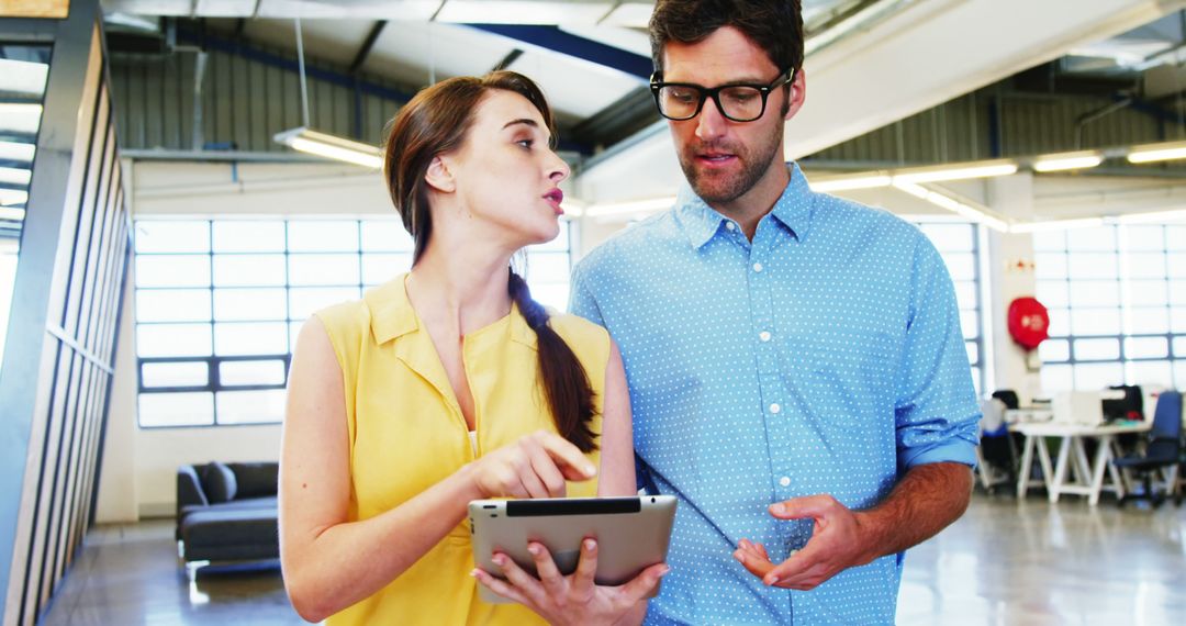 Business Meeting: Colleagues Collaborating on Tablet