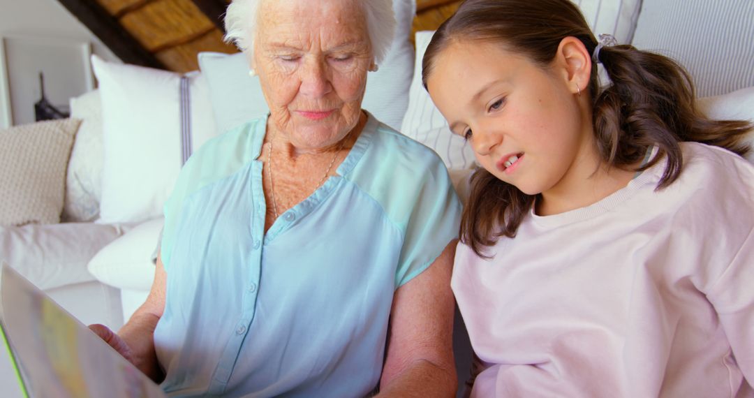 Grandmother Reading Storybook to Granddaughter at Home - Free Images, Stock Photos and Pictures on Pikwizard.com