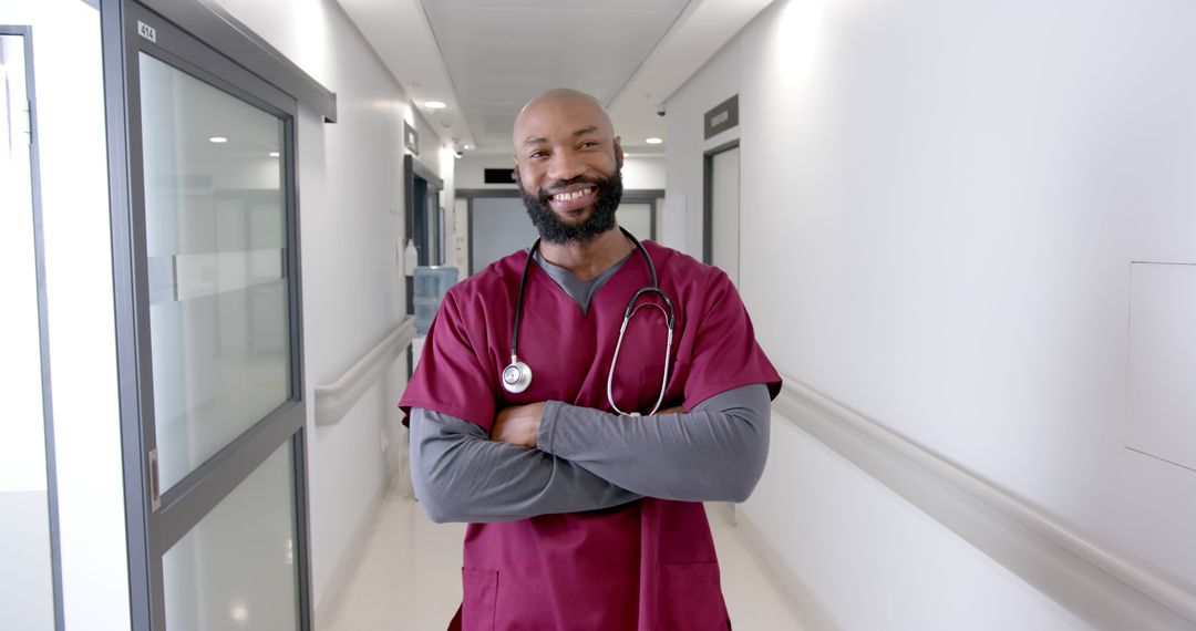 Confident African American male nurse standing in hospital corridor - Free Images, Stock Photos and Pictures on Pikwizard.com