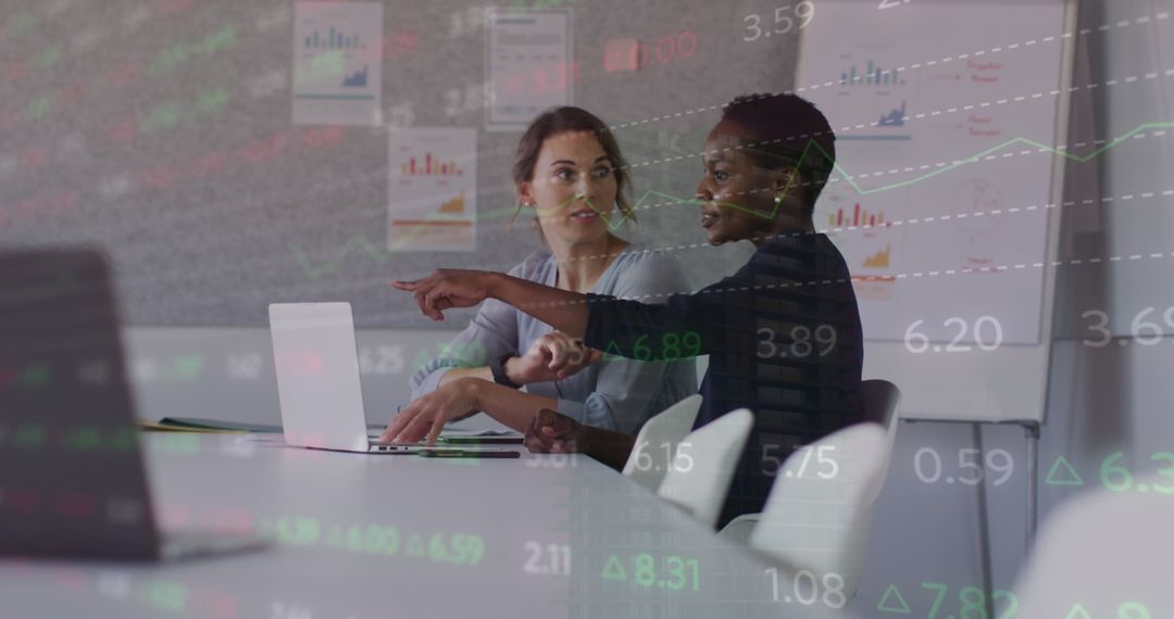 Diverse Female Colleagues Analyzing Financial Data on Laptop - Free Images, Stock Photos and Pictures on Pikwizard.com