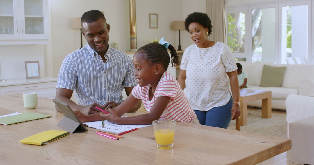 Happy Family Bonding Over Homework Using Tablet at Home
