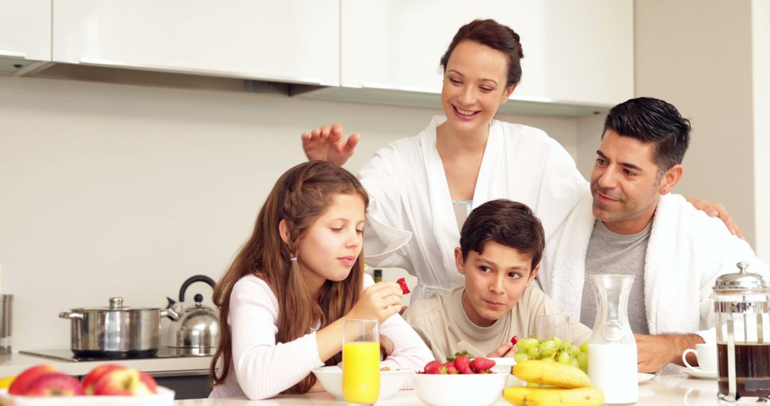 Happy Family Eating Breakfast in Modern Kitchen - Free Images, Stock Photos and Pictures on Pikwizard.com