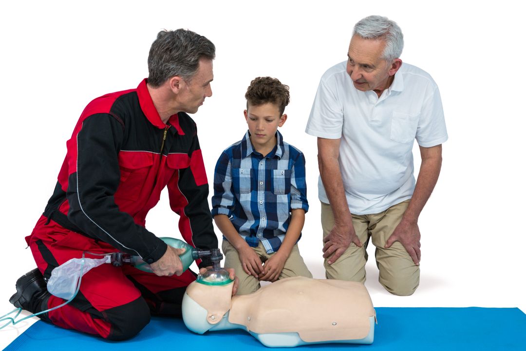 Paramedic training cardiopulmonary resuscitation to senior man and boy - Free Images, Stock Photos and Pictures on Pikwizard.com