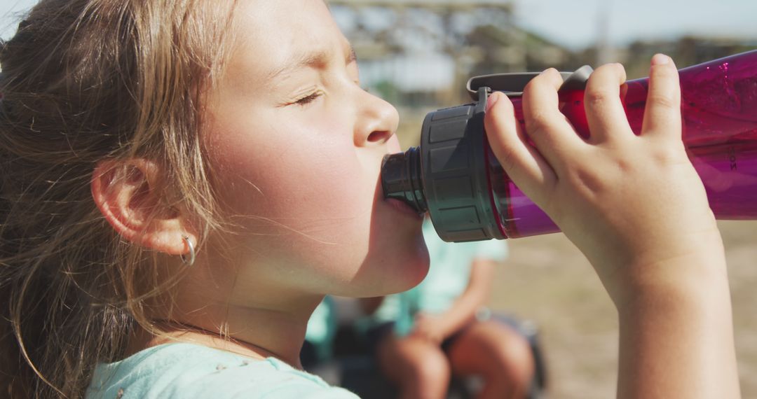 Girl Drinking Water from Bottle on Sunny Day - Free Images, Stock Photos and Pictures on Pikwizard.com