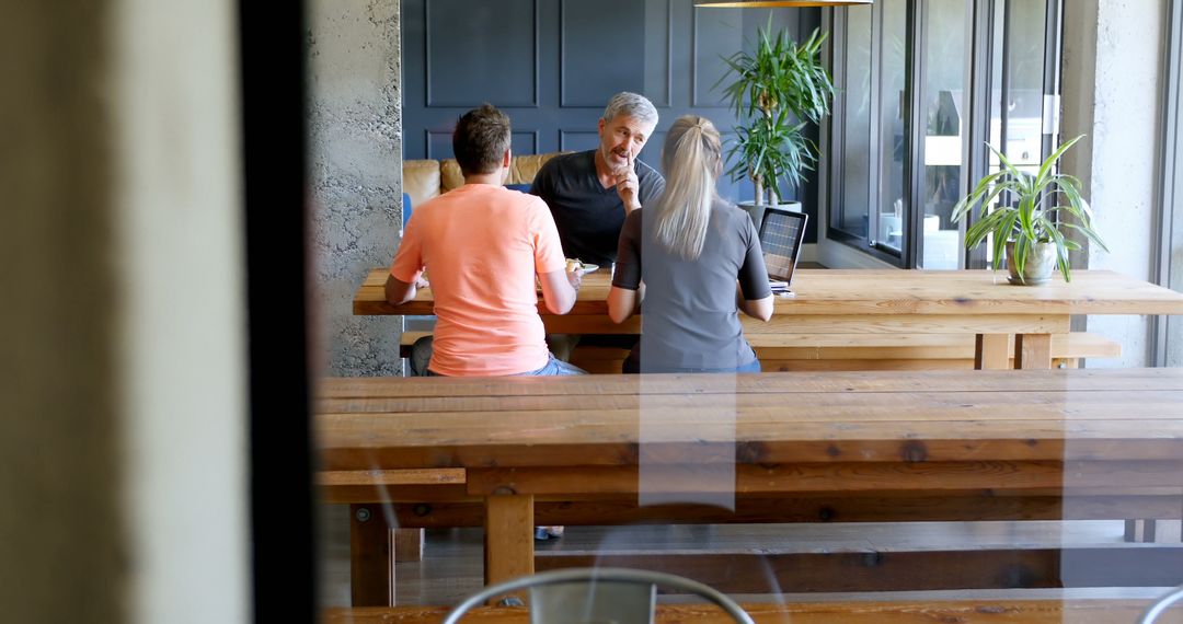 Colleagues Engaging in Dialogue During Casual Office Lunch
