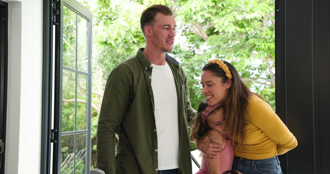 Happy Family Returning Home Embracing After Vacation