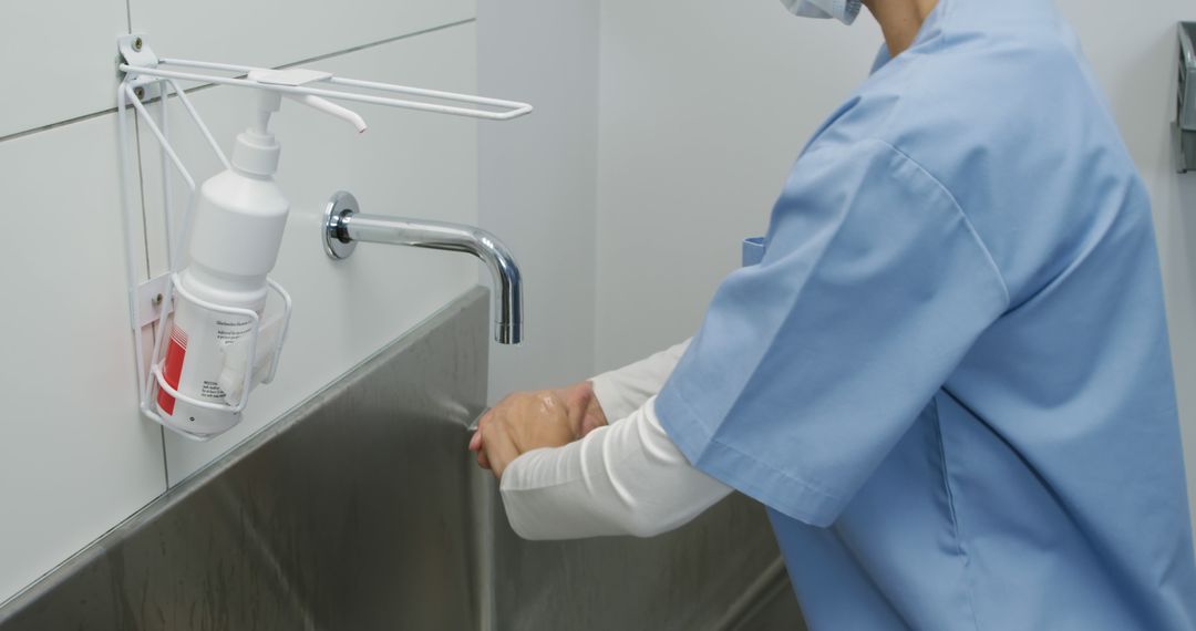 Healthcare worker washing hands in hospital room during routine hygiene - Free Images, Stock Photos and Pictures on Pikwizard.com