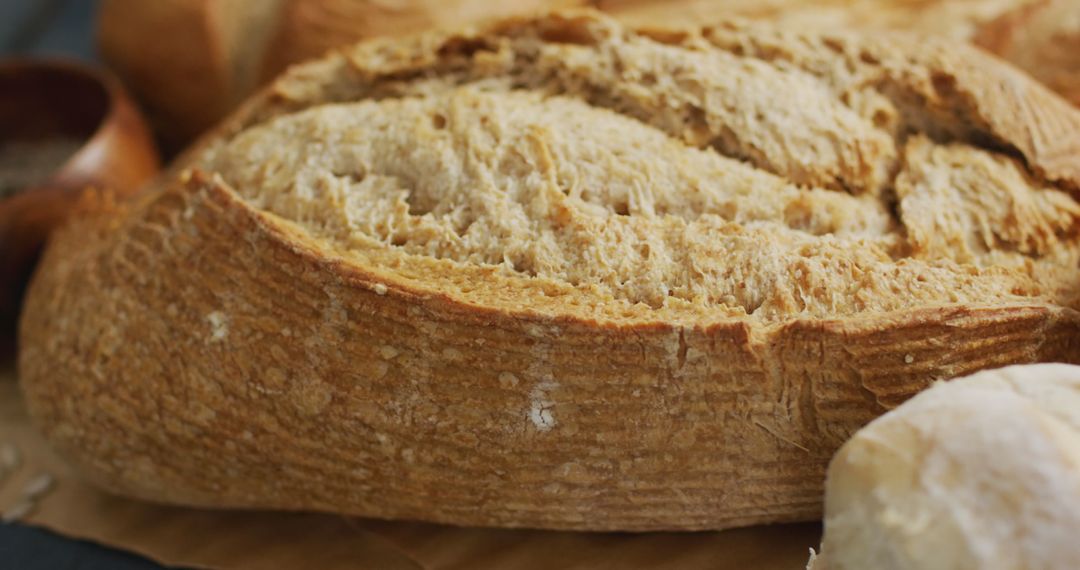 Whole Grain Bread Loaf on Rustic Wooden Worktop