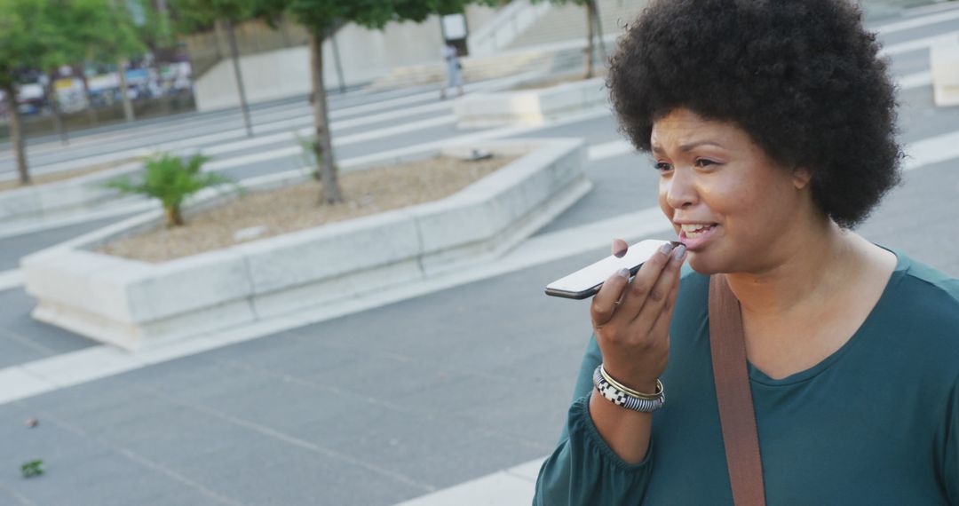 Happy Biracial Woman Talking on Smartphone in Urban Setting