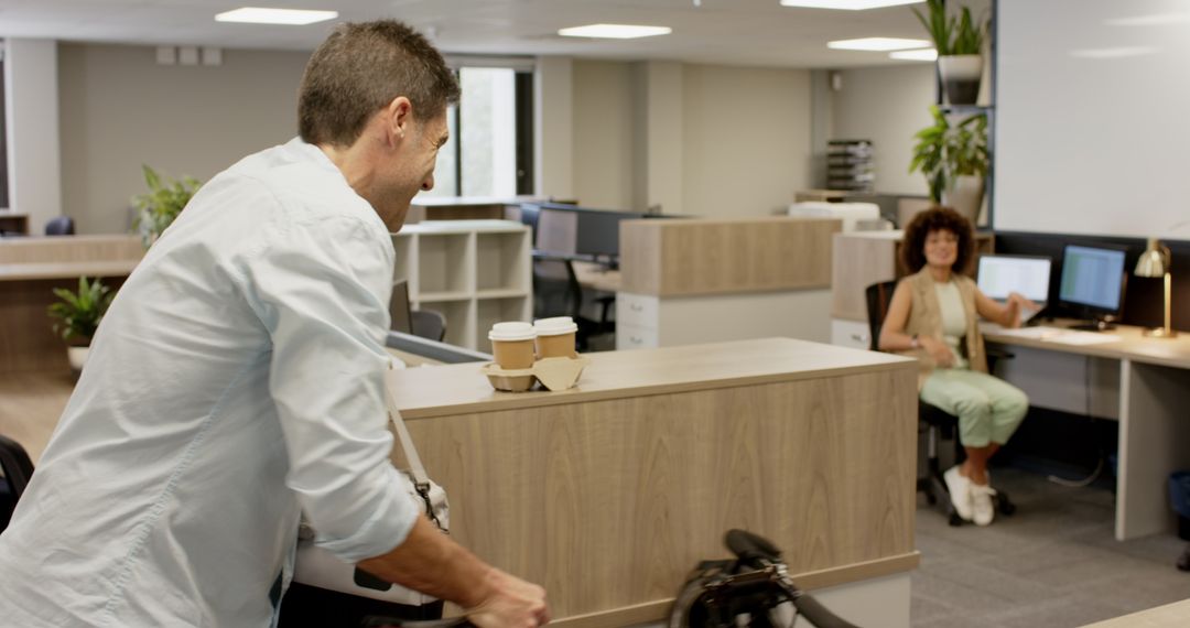 Colleagues Collaborating with Bicycle in Modern Office