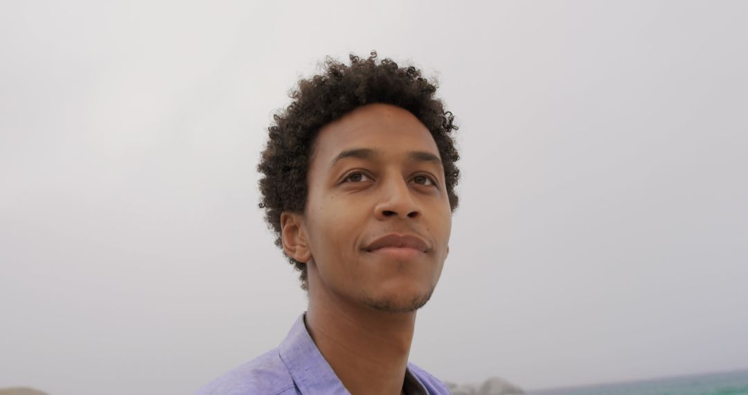 Thoughtful Man on Beach with Calm Expression
