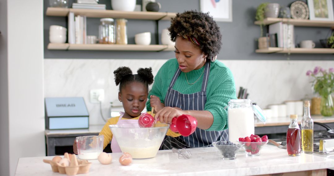 Happy African American Mother and Daughter Enjoying Pancake Making Together at Home - Free Images, Stock Photos and Pictures on Pikwizard.com