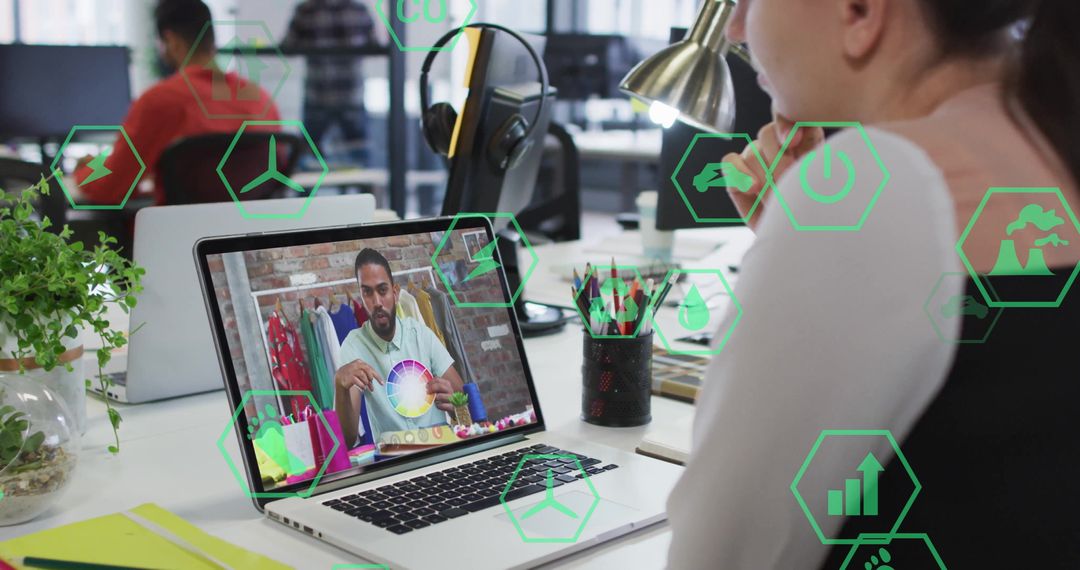 Creative Professional Engaging in Eco-Friendly Design on Laptop