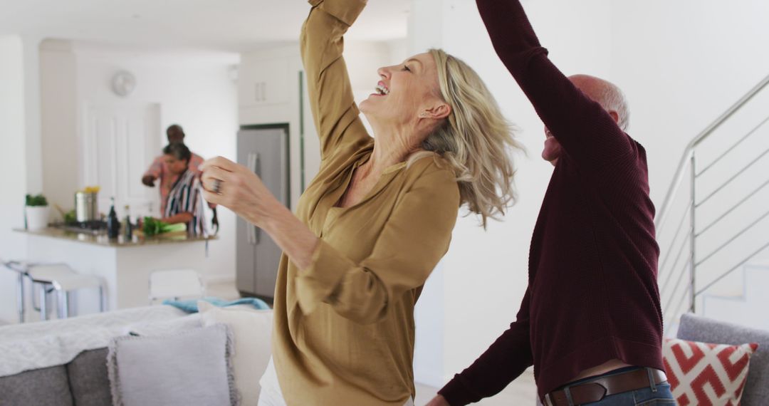 Joyful Senior Couple Dancing at Home in Bright Kitchen and Living Room - Free Images, Stock Photos and Pictures on Pikwizard.com