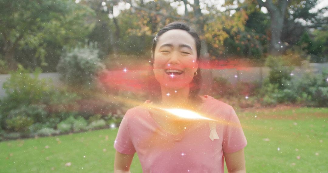 Joyful Woman in Garden with Cosmic Light Effect
