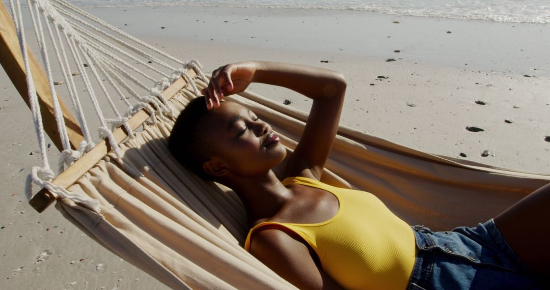 Young Woman Relaxing on Hammock beside Seashore - Free Images, Stock Photos and Pictures on Pikwizard.com