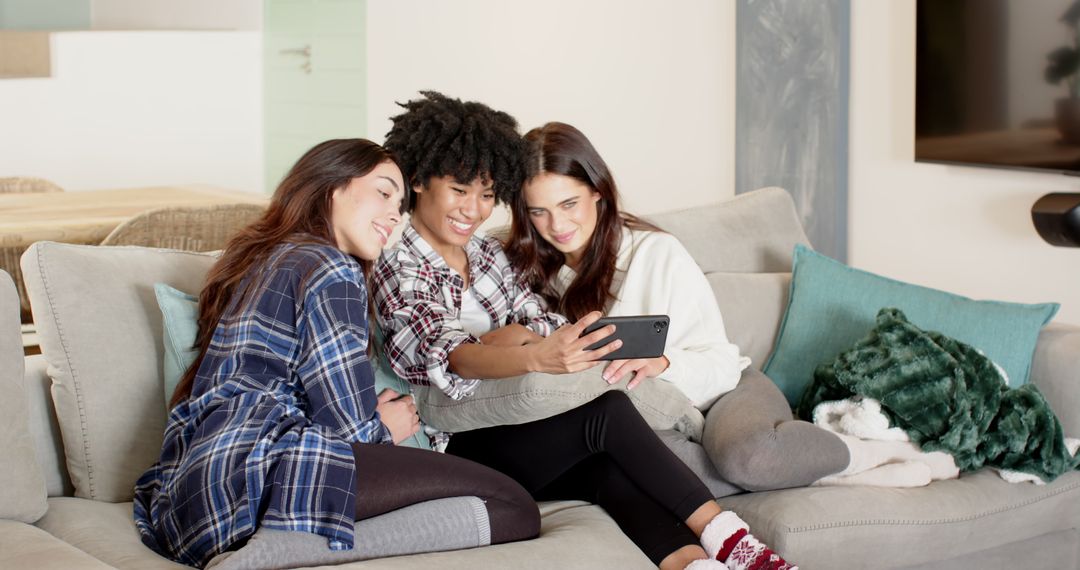 Diverse Friends Relaxing on Sofa Sharing Tablet at Home
