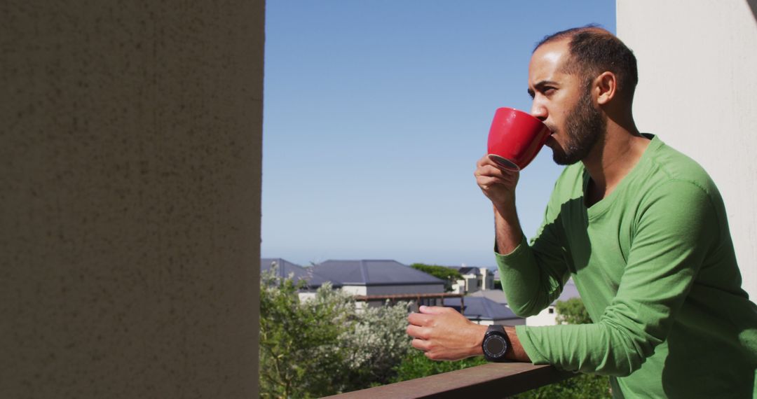 Man Drinking Coffee on Balcony on Sunny Morning - Free Images, Stock Photos and Pictures on Pikwizard.com