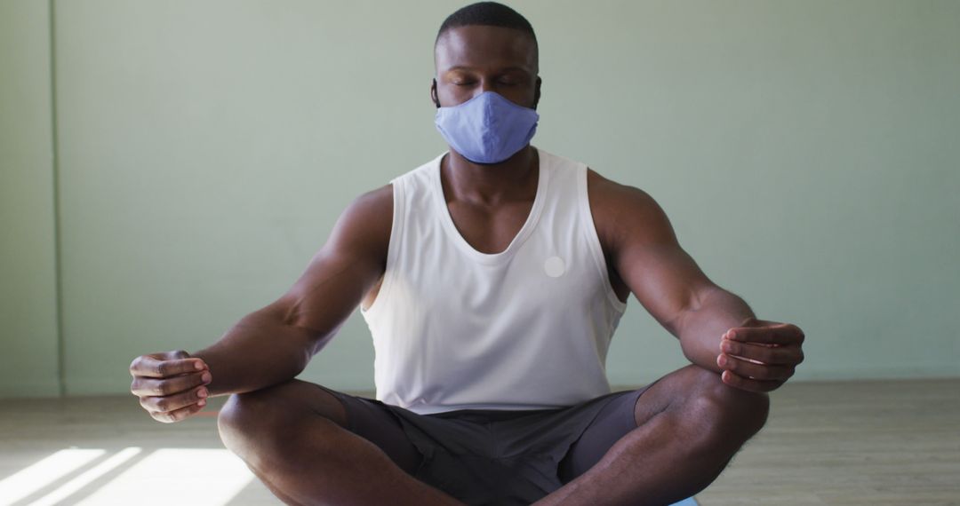 Man Meditating With Face Mask Indoors for Safe Yoga Practice - Free Images, Stock Photos and Pictures on Pikwizard.com