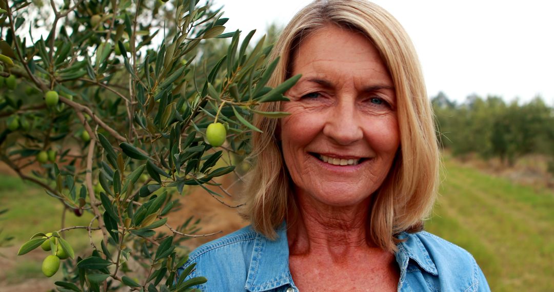 Senior Woman Smiling in Olive Grove - Free Images, Stock Photos and Pictures on Pikwizard.com