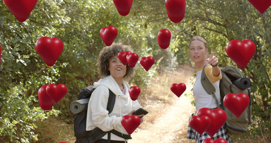 Friends hiking on forest trail pointing and discovering floating red hearts overlay