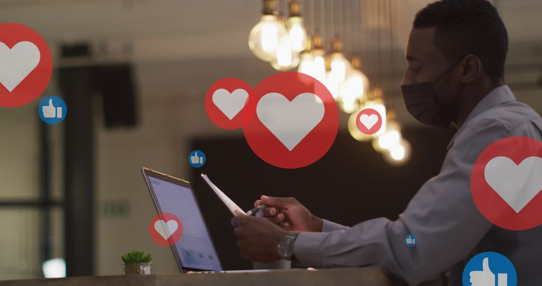 Businessman Using Laptop with Social Media Icons Overlay