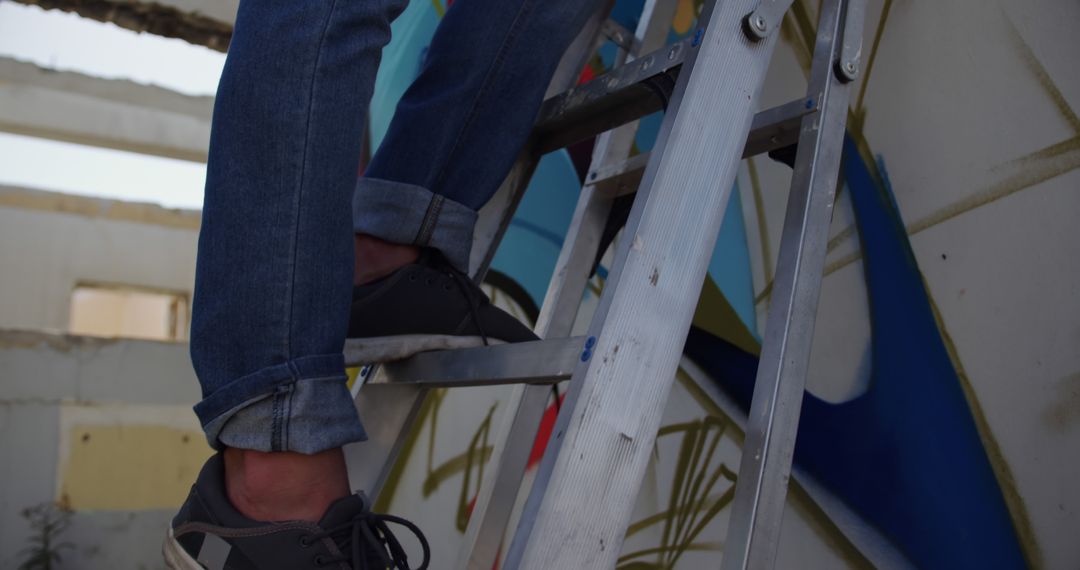 Person Climbing Ladder in Abandoned Building for Graffiti - Free Images, Stock Photos and Pictures on Pikwizard.com