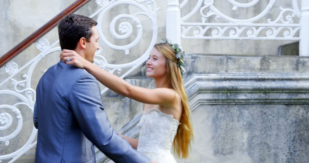 A young Caucasian bride and groom share a romantic moment on a staircase, with copy space - Free Images, Stock Photos and Pictures on Pikwizard.com