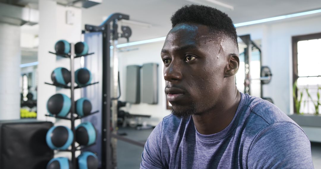 Focused African American Athlete Taking Rest in Modern Gym