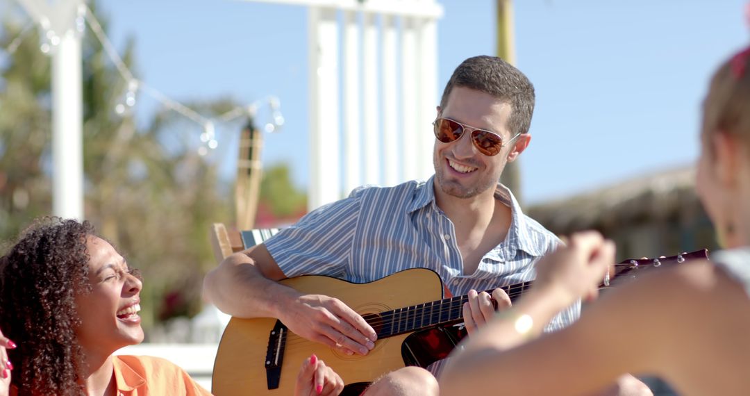 Group of Friends Enjoying Beachside Guitar Session - Free Images, Stock Photos and Pictures on Pikwizard.com